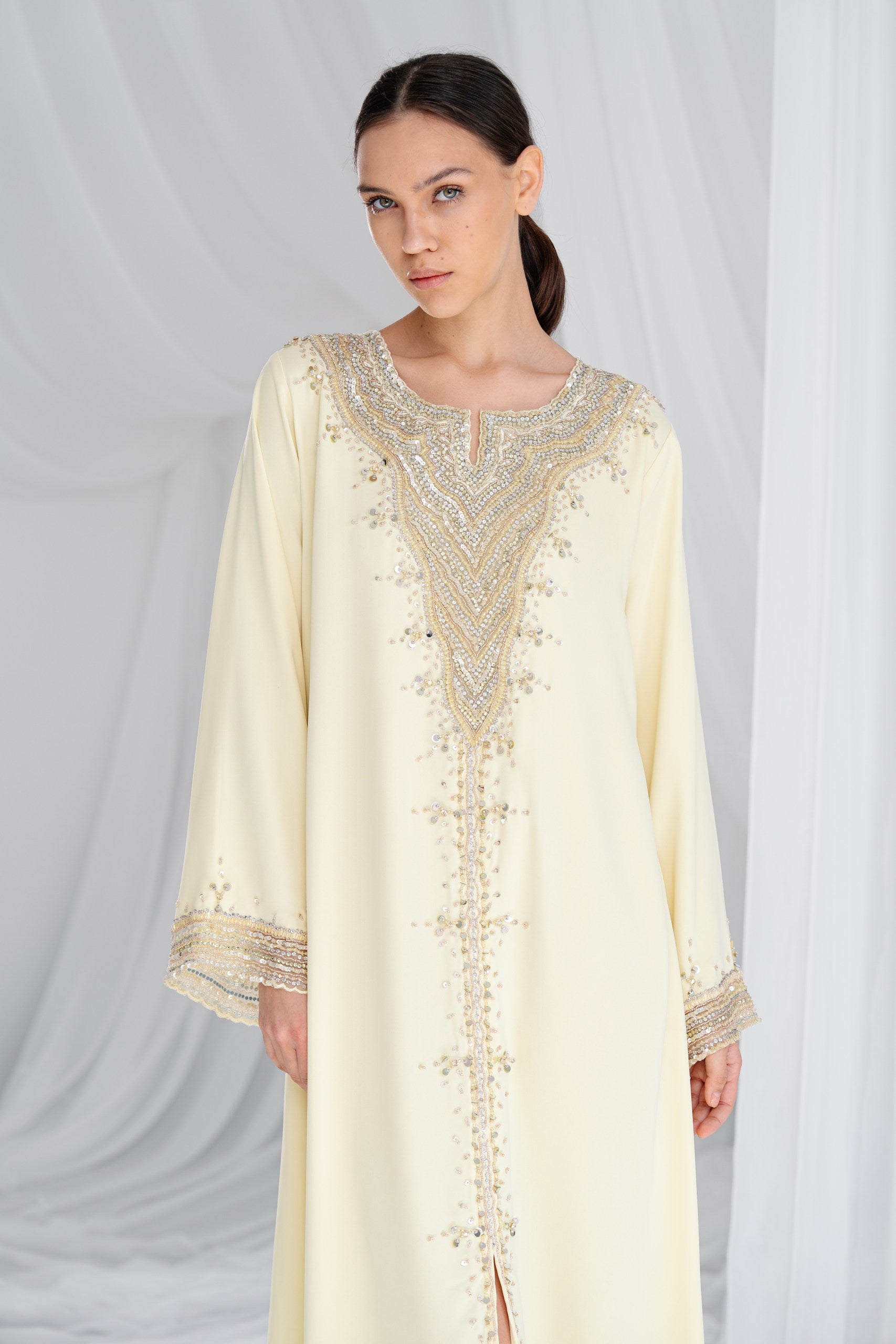 Woman wearing pastel yellow kaftan